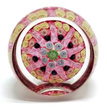 Millefiori paperweight with central cane, concentric ring & 9 radial twists separating cane groups
