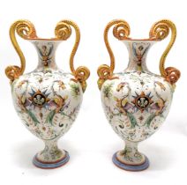 Pair of large Italian Majolica vases with serpent scroll detail handles and profusely hand decorated