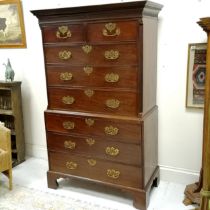 Antique mahogany chest on chest with blind fret and Greek key detailed cornice terminating on