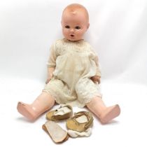 Vintage composite doll, slight damage to foot and marks to the head. 60cm .