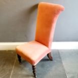 Antique walnut framed high back nursing chair,on original brass castors, upholstered in a coral