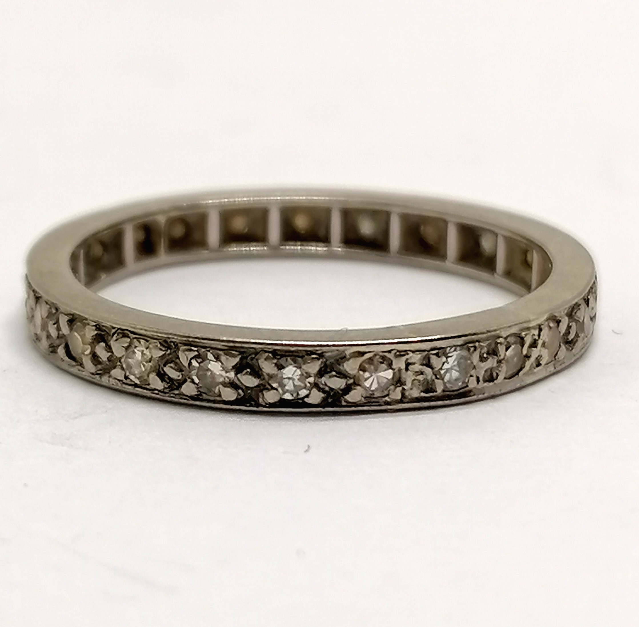 Unmarked white gold (touch tests as higher carat) diamond set eternity ring - size P & 3.2g total