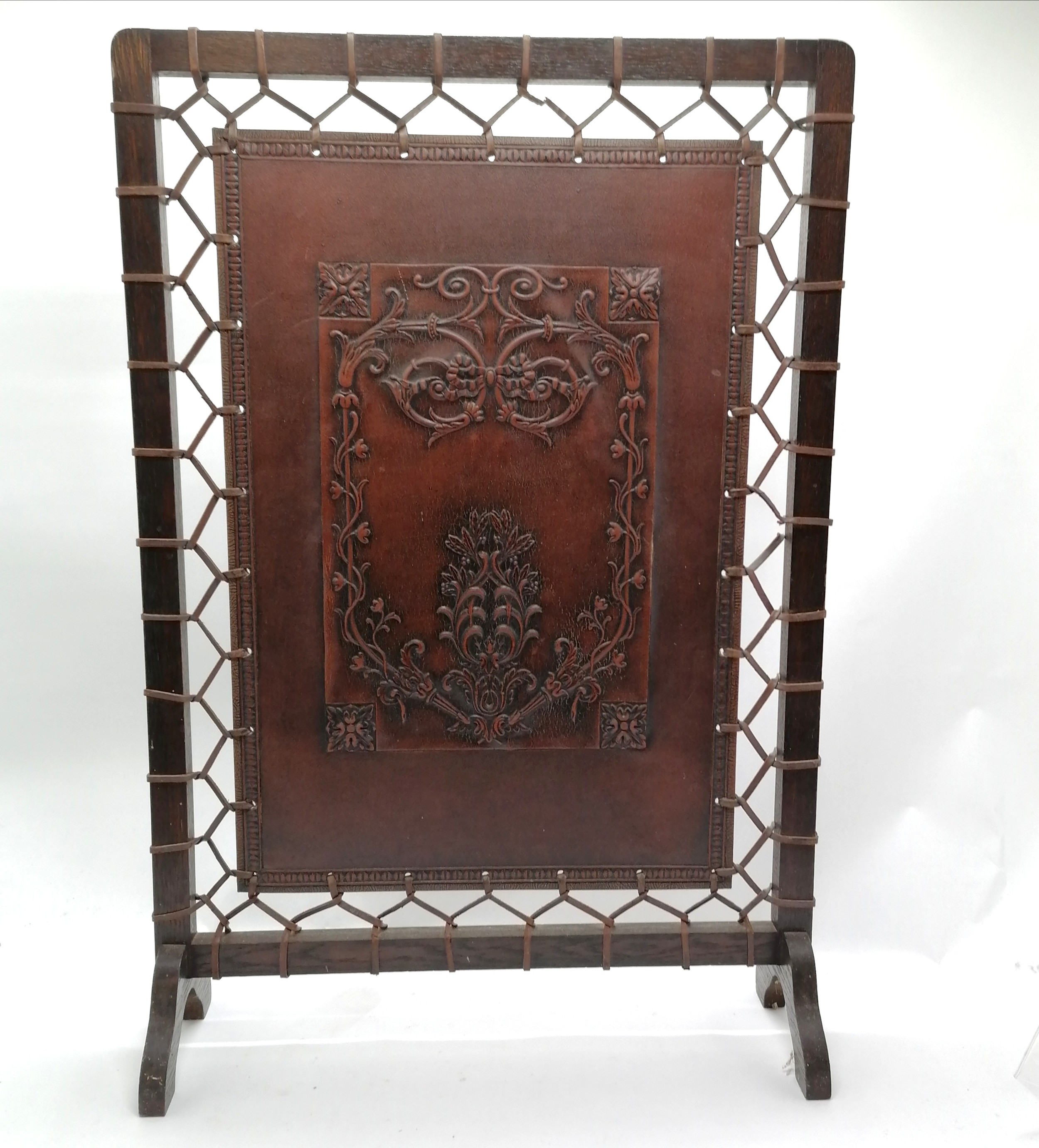Liberty Arts & Crafts leather tooled fire screen attached to a wooden frame with leather stringing