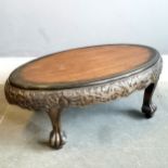 Oriental hand carved oval coffee table on 4 claw feet - 80cm x 44cm x 31cm high ~ in used condition