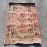 Pink wool grounded rug ~ 172cm x 118cm - no obvious signs of damage, slight creasings