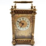 Antique brass cased carriage clock with fluted column detail - 13cm high & running at time of