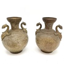 Indian pair of brass 2 handled vases - 21cm high with engraved detail of dancers to the bodies