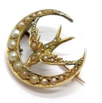 Unmarked antique gold (touch tests as 15ct) brooch in the form of a crescent with bird set with