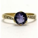 9ct hallmarked gold iolite (?) / diamond crossover ring - size L & 1.9g total weight - stone has