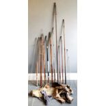 Collection of assorted vintage fishing rods and some hessian storage bags etc.