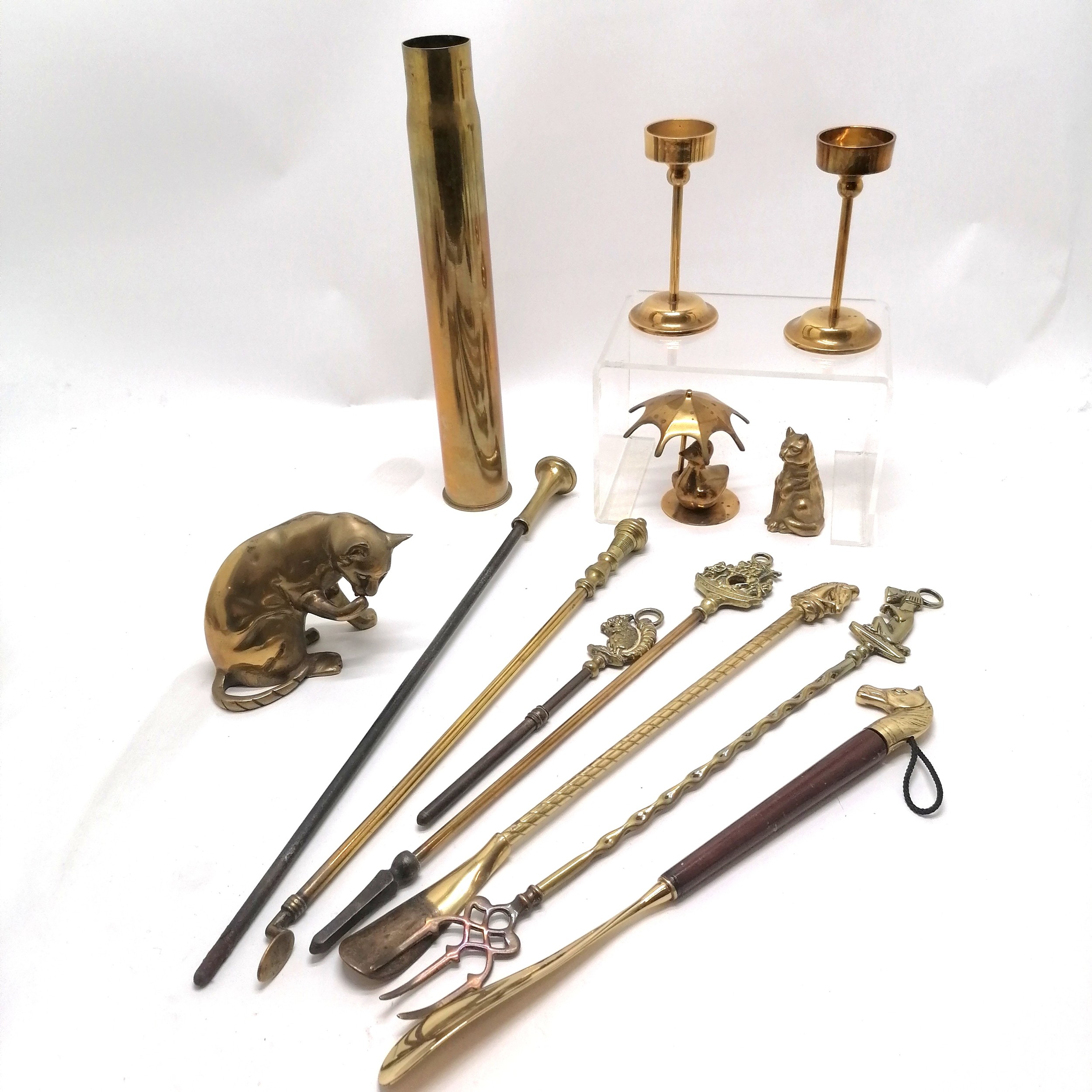 1919 brass shell case, 2 horse head shoe horns, 2 pokers, dog toasting fork, 2 brass cats tallest