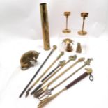1919 brass shell case, 2 horse head shoe horns, 2 pokers, dog toasting fork, 2 brass cats tallest