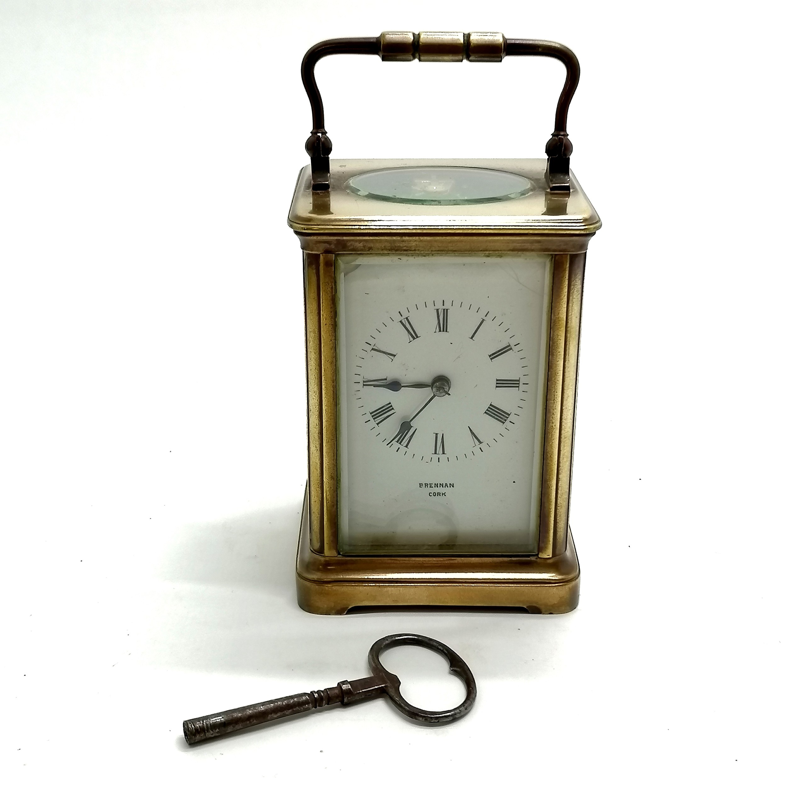 Antique brass carriage clock marked Brennan Cork to porcelain dial - 12cm high x 9cm x 8cm ~ has key