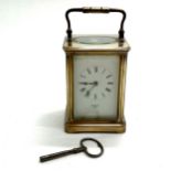 Antique brass carriage clock marked Brennan Cork to porcelain dial - 12cm high x 9cm x 8cm ~ has key