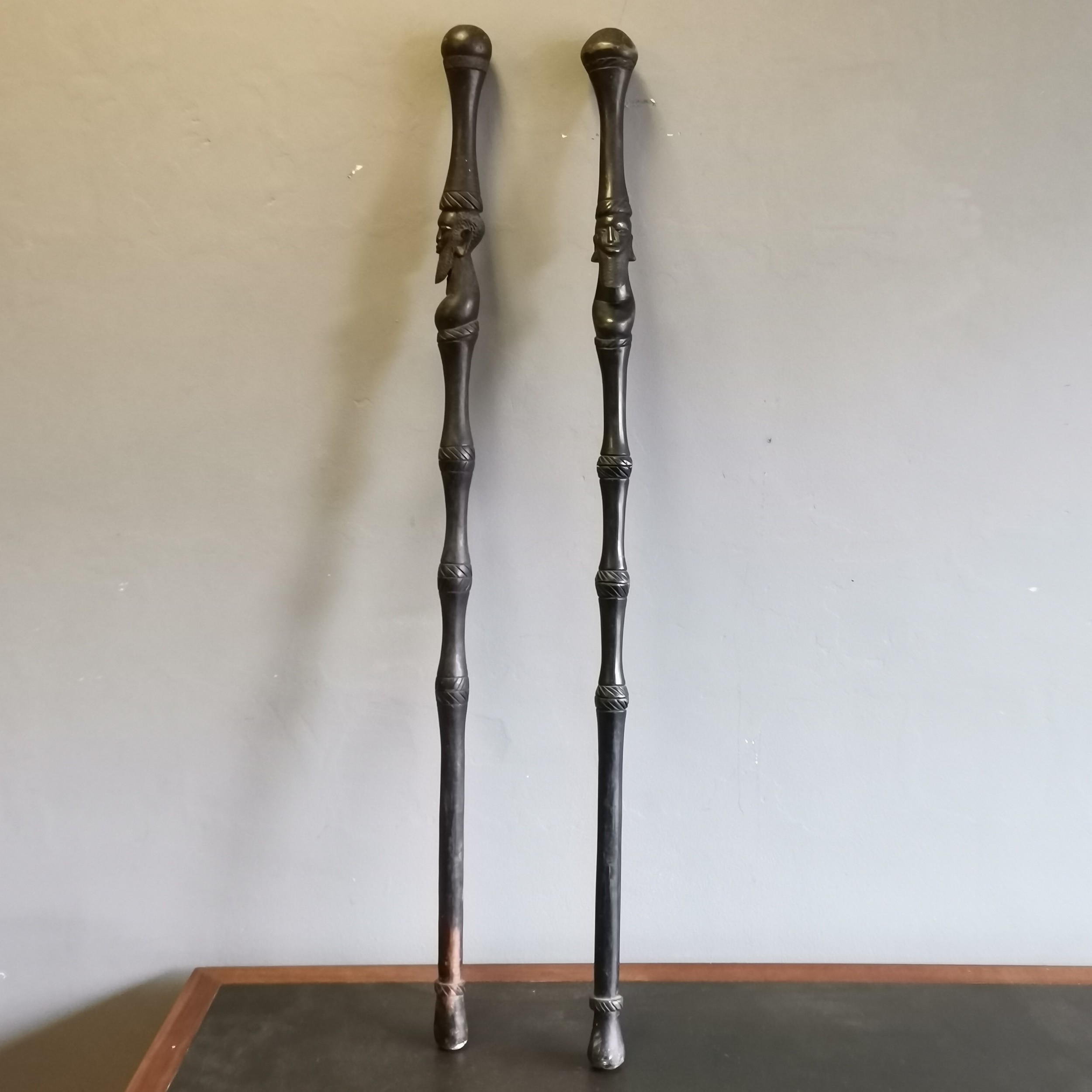 2 African Tribal hardwood carved walking sticks/staffs decorated with carved heads and decoration,