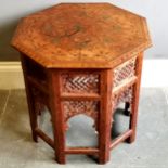 Vintage Indian teak collapsible table with brass inlay and carved fretwork decoration, 57cm diameter