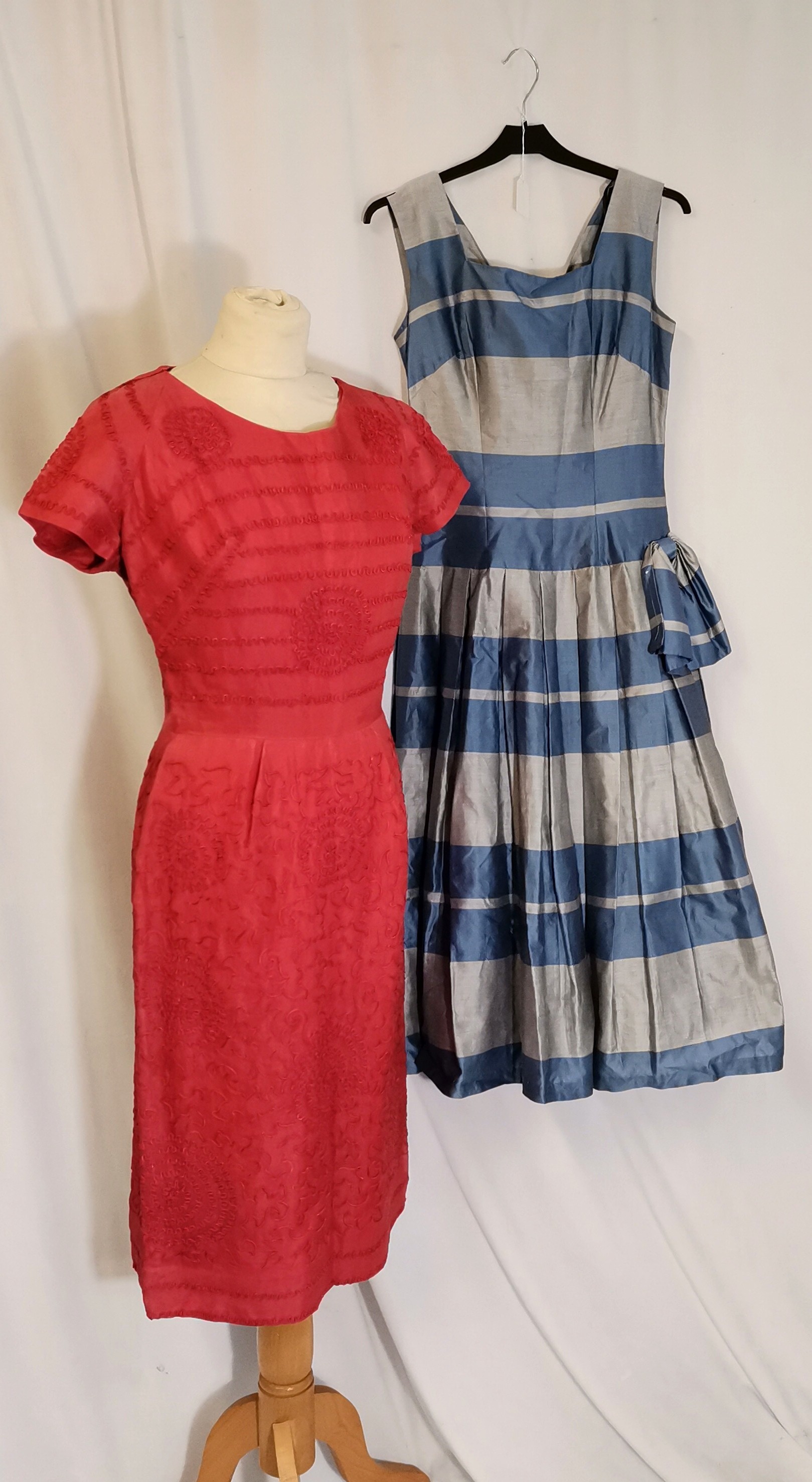 2 1950s dresses 1 blue and grey taffeta with bow at waist t/w coral chiffon with overlay pattern