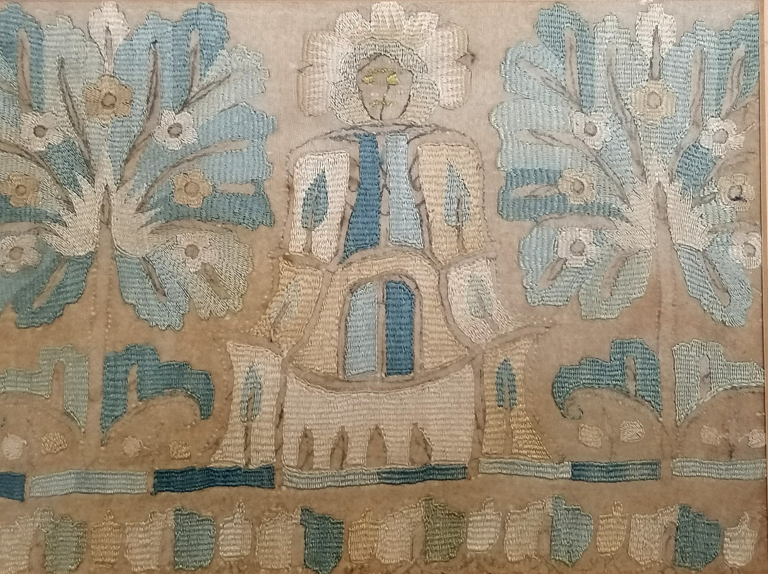 Antique framed needlepoint panel of Aztec style figures and stylised tree's, 72 cm wide, 36.5 cm - Image 2 of 3