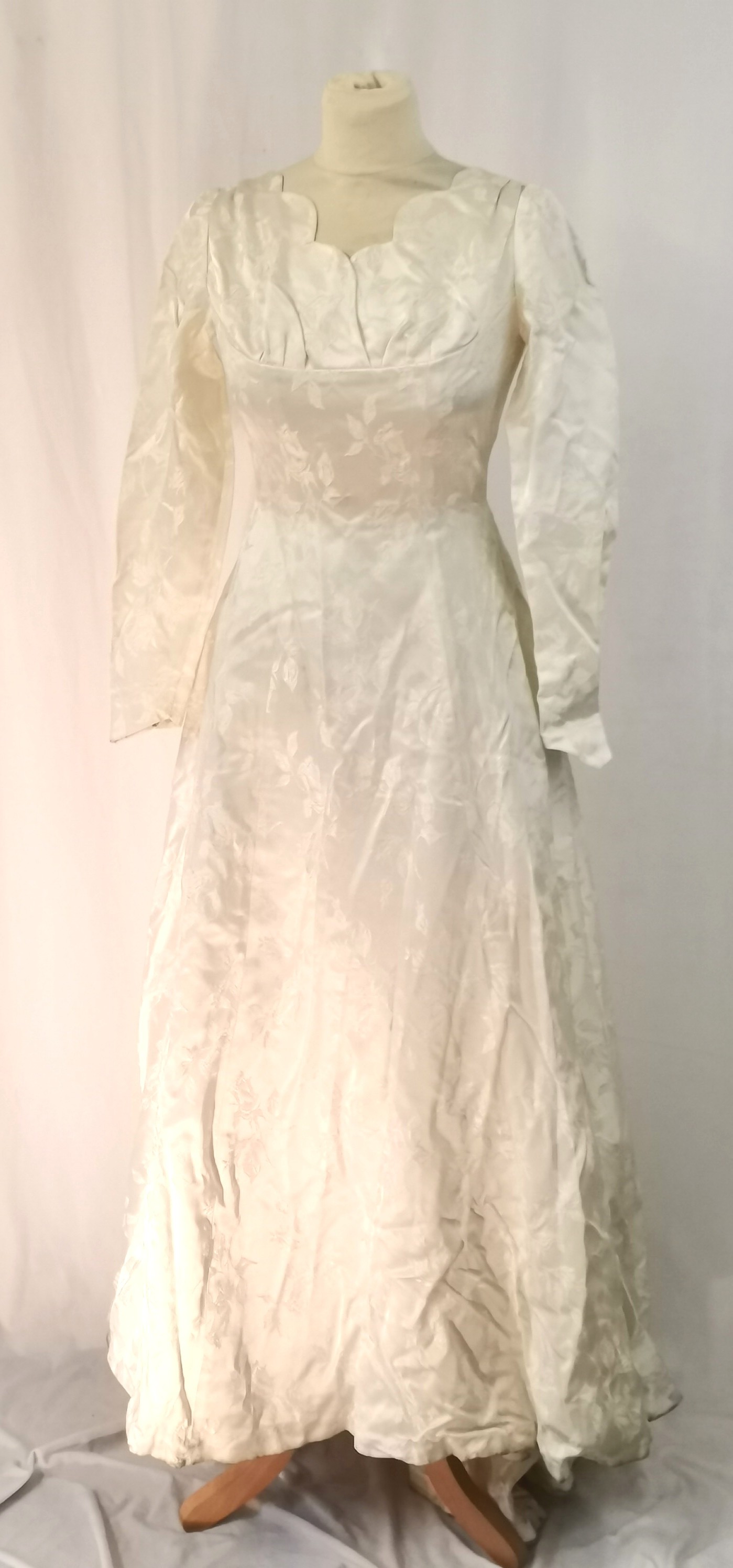 1950s Satin long sleeved wedding dress measuring 92cm bust. In used condition with staining to the