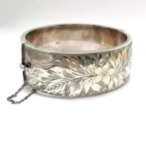 Silver hallmarked bangle with engraved detail to front (24mm wide) by Ronex - 6cm internal
