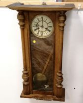 Oak cased wall clock with a gong strike mechanism with key & pendulum - 68cm x 45cm ~ has crack to