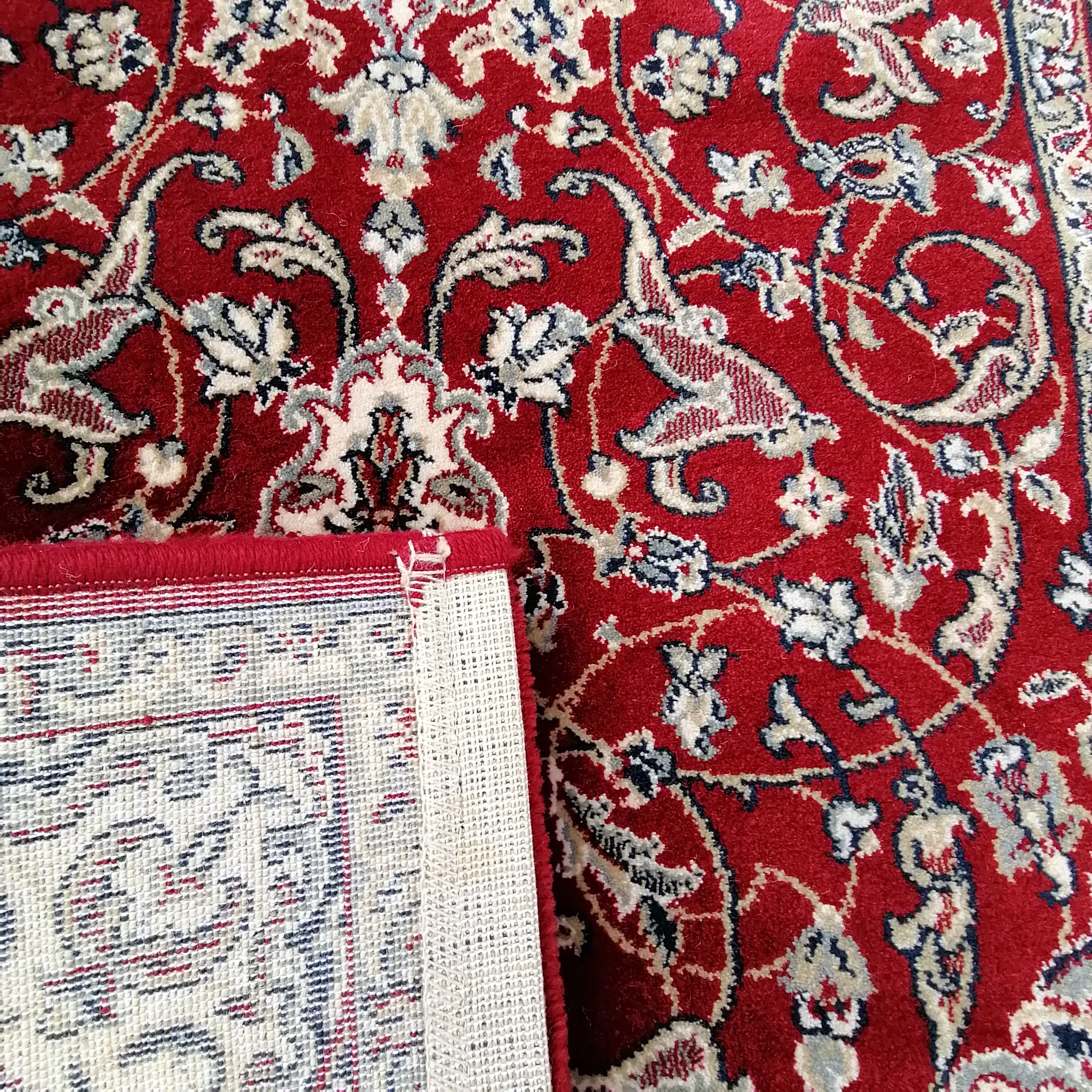 Small red grounded wool rug with cream detail to the border 158cm x 78cm - in good used condition - Image 2 of 2