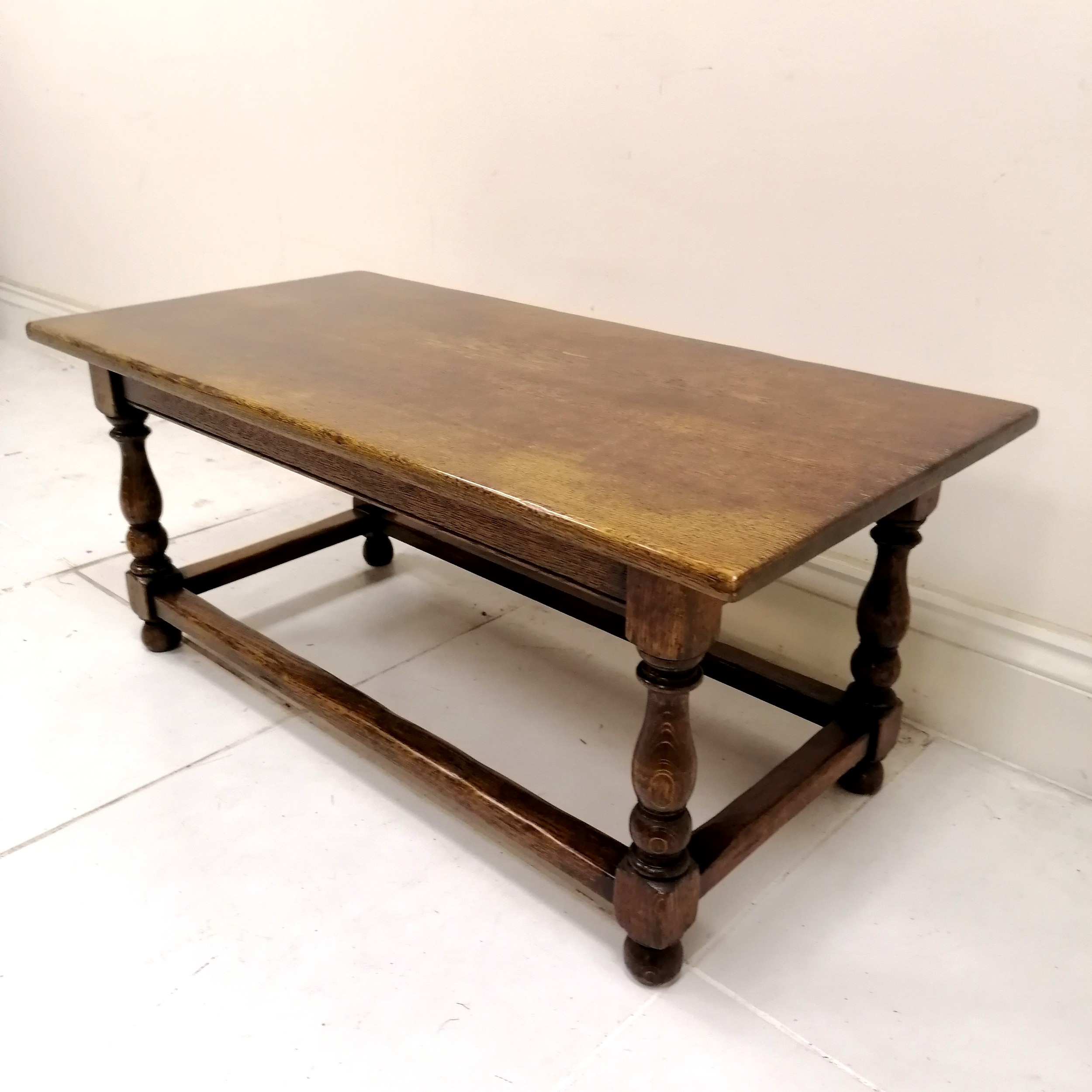 Oak refectory style coffee table with stretchered and turned base, in good used condition, 107 cm