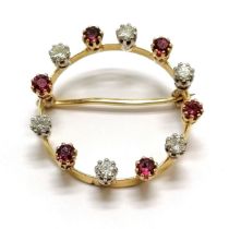 Unmarked (touch tests as 18ct) gold circular brooch set with 6 rubies & 6 diamonds - 3cm