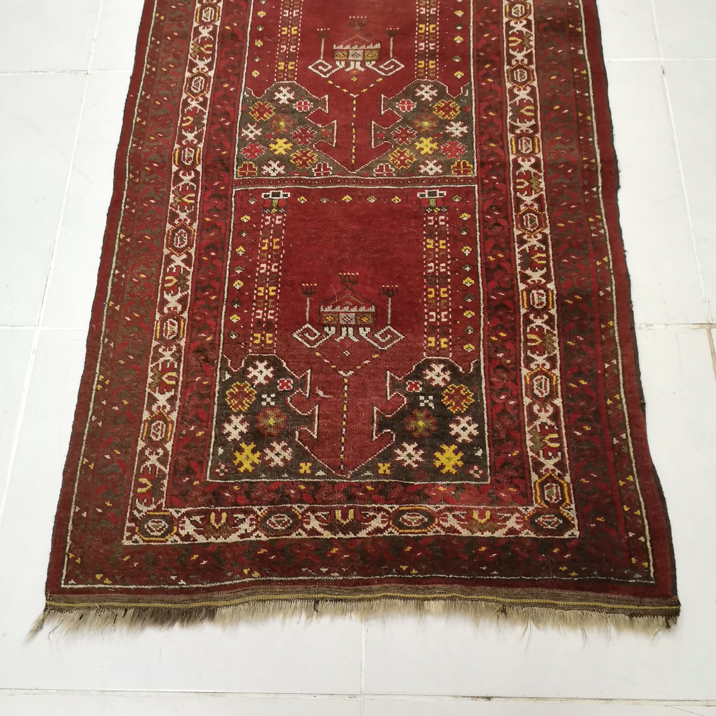 Red ground rug with all over decoration within multiple borders ~ 102cm x 170cm - Image 2 of 3