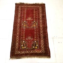 Red ground rug with all over decoration within multiple borders ~ 102cm x 170cm