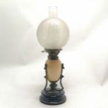 Antique Art Nouveau oil lamp with a stoneware font in a stylised brass mount on a black ceramic base