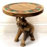 Indian carved teak circular side table with carved floral decoration to top, the base having a