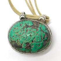 Antique Islamic carved turquoise amulet set in unmarked silver with text to one side and a deer to