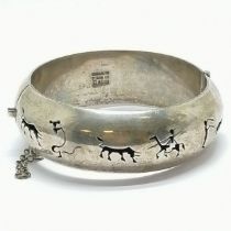 Mexican sterling silver bangle with cut-out bullfighting detail - 5.8cm internal diameter & 44g