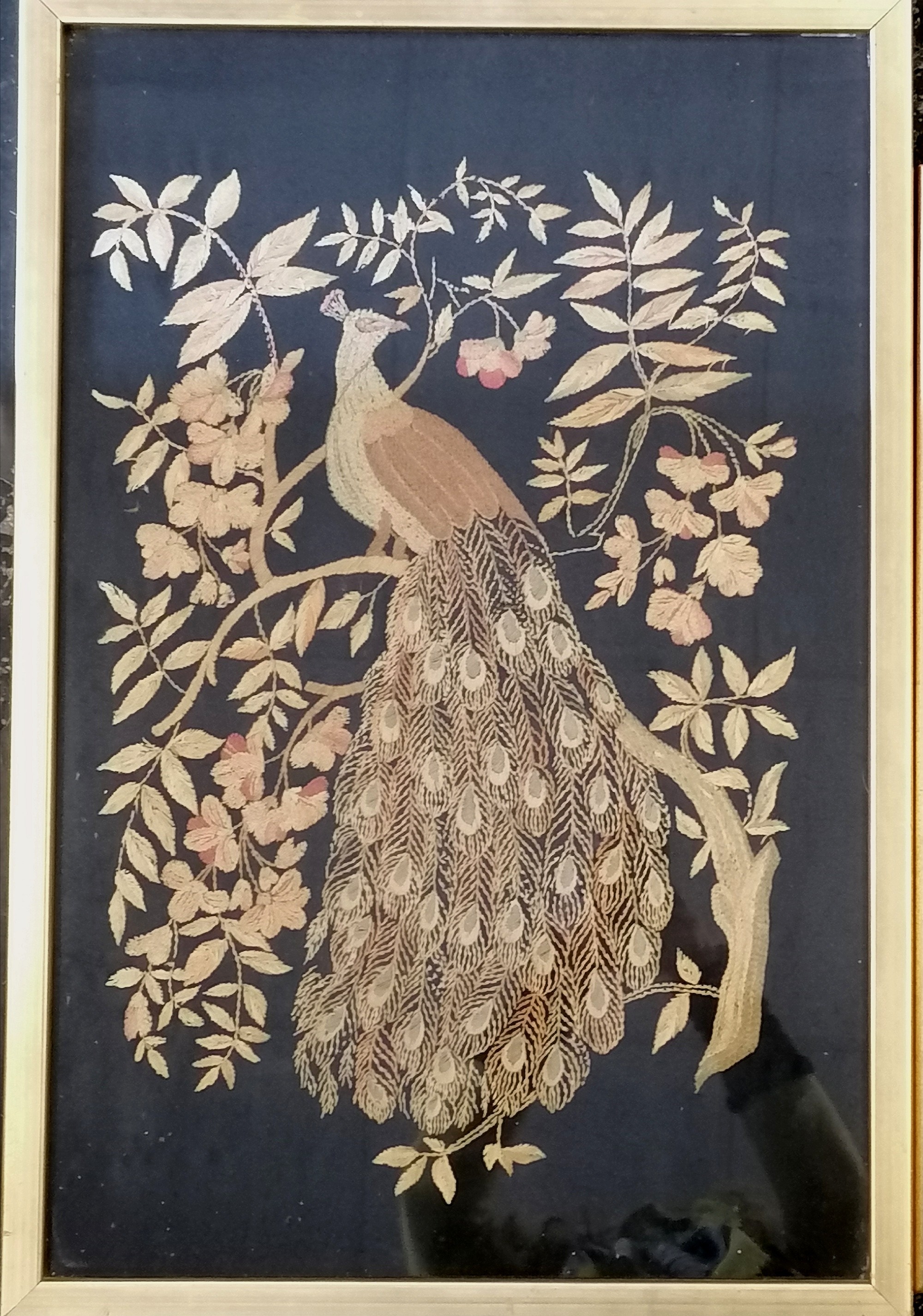 Framed needlepoint of a peacock, 46 cm wide x 69 cm high, to include frame, and a floral display