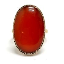 Antique large unmarked gold cabochon cornelian stone set ring in the Oriental taste - size N½ & 5.8g