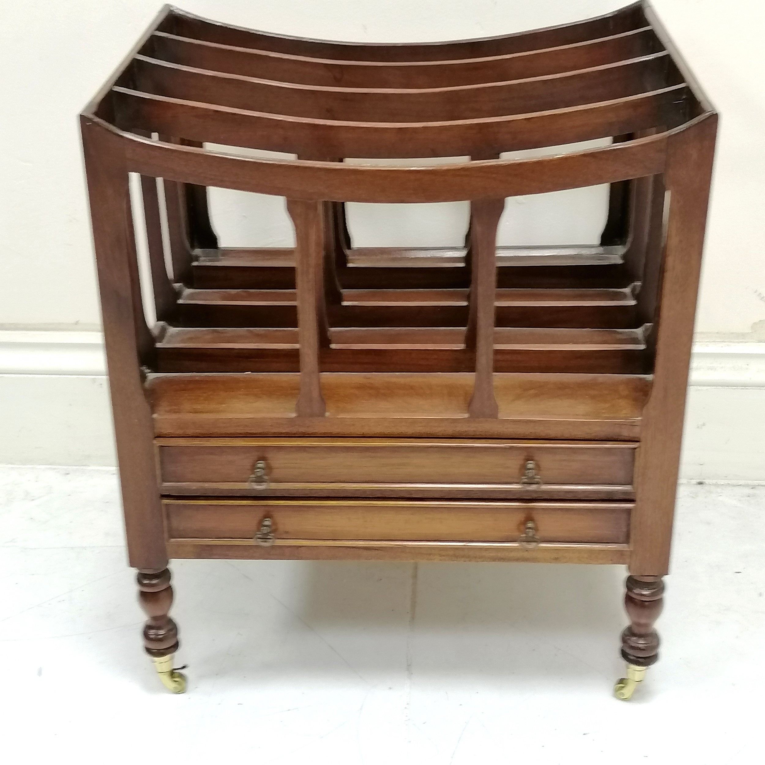 Mahogany reproduction Canterbury fitted with 2 drawers on turned legs terminating on castors, in