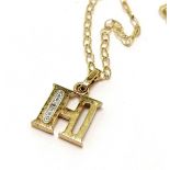 9ct marked gold H pendant set with a diamond on a 9ct marked gold 46cm chain - 1.2g total weight