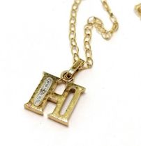 9ct marked gold H pendant set with a diamond on a 9ct marked gold 46cm chain - 1.2g total weight