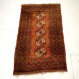 Brown ground rug with 5 central medallions within large border ~ 110 cm wide x 185 length
