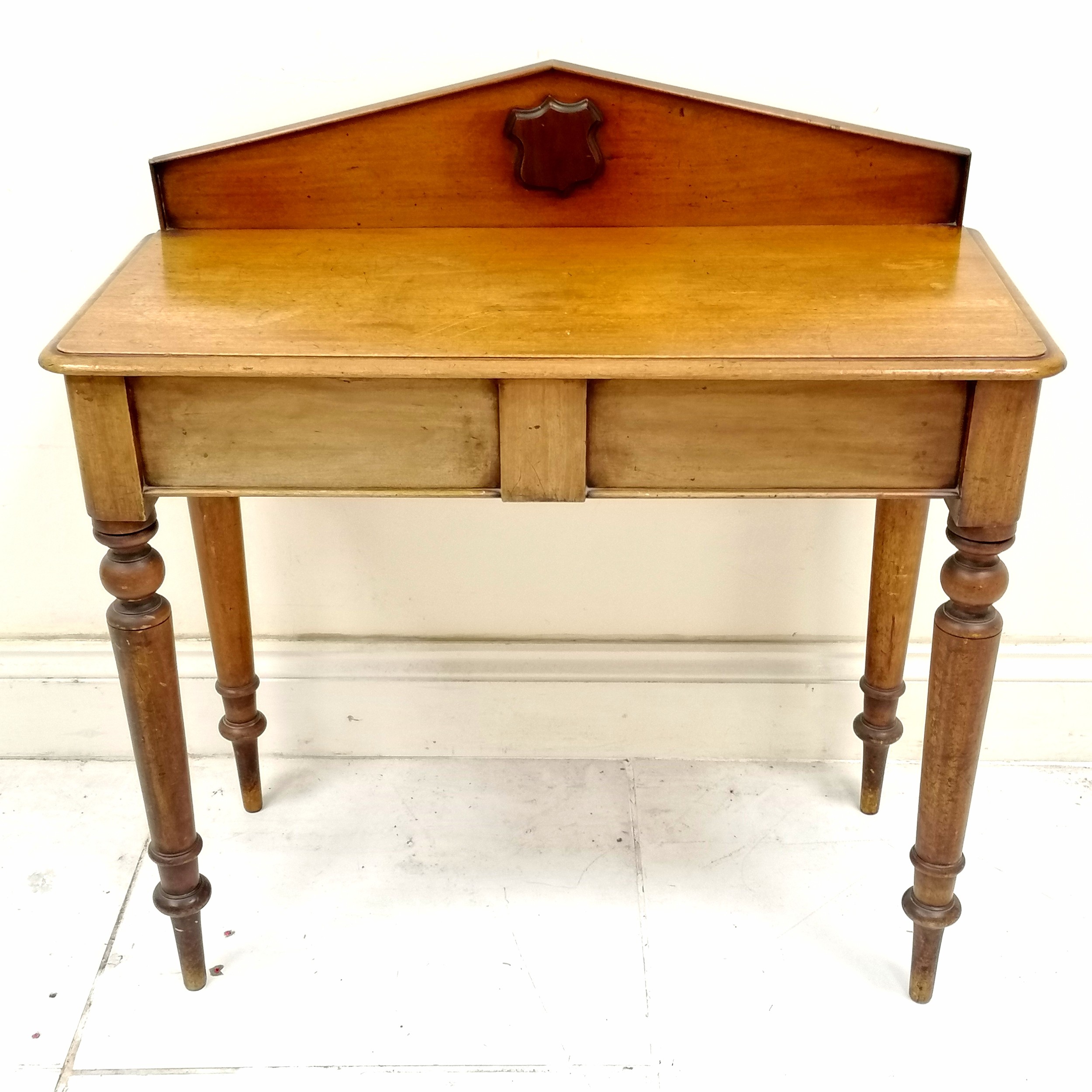 Antique mahogany hall table with decorated with carved shield, on turned legs, in used condition, 90