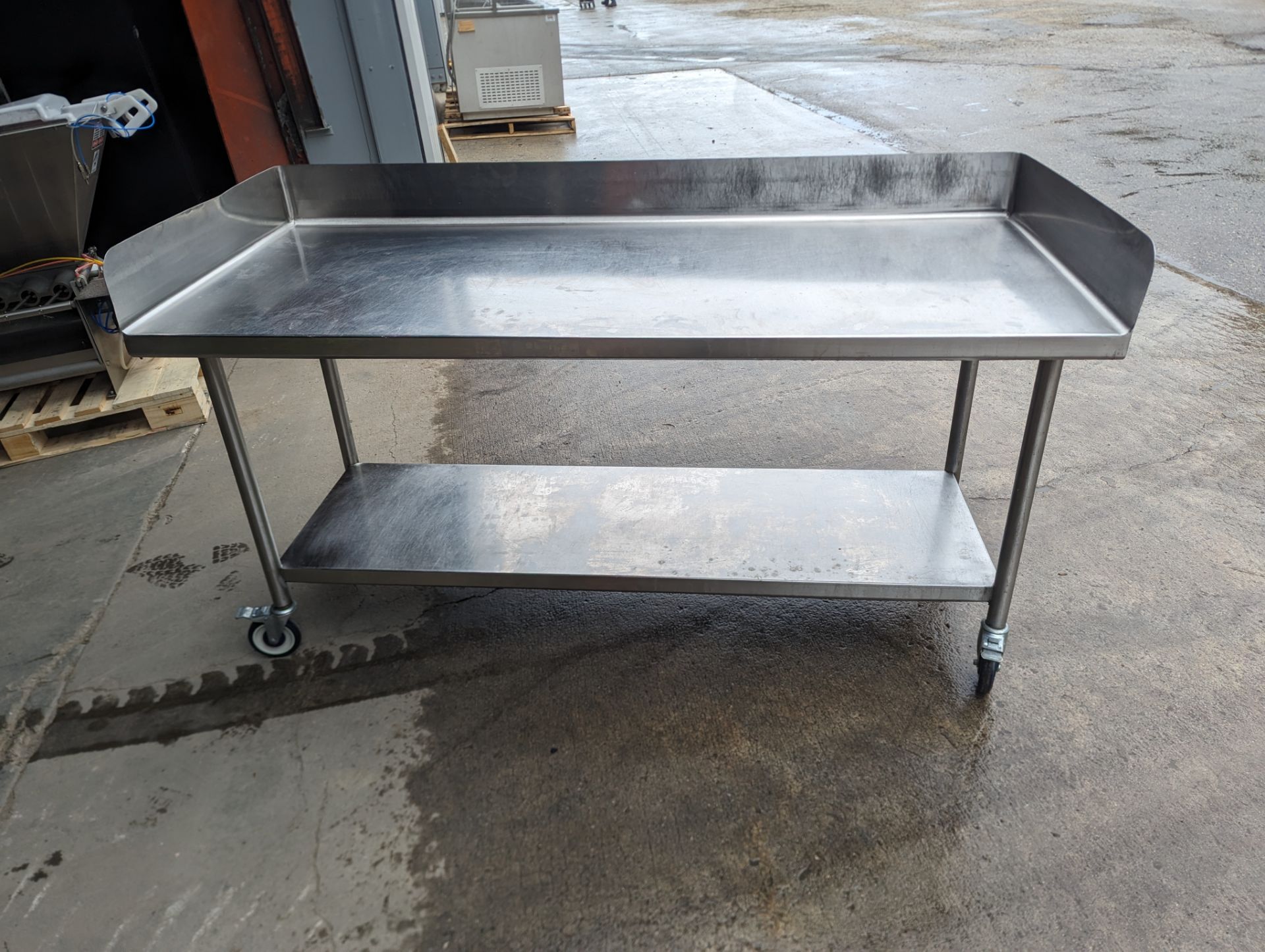 Approx. 6 Ft Stainless Steel Table with Back Splash on Casters