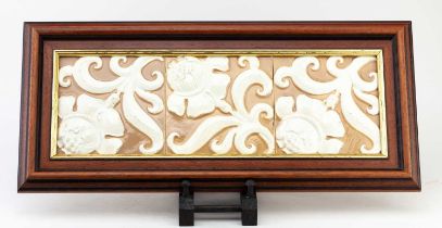 DOULTON LAMBETH; a framed trio of tiles, relief decorated with floral sprays, each 14 x 14cm,