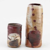 † ADAM FREW (born 1981); a cylindrical stoneware vase covered in oatmeal glaze with copper red and