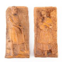A pair of Continental terracotta plaques representing a farm hand and maiden clutching her child, 18