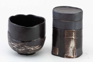 † ALEX HAGEN; an oval stoneware box and cover partially covered in black glaze, height 12.5cm, and a