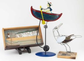 A contemporary painted metal swinging figure of a sailor in a rowing boat, height 44cm, a wooden