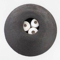 † ALISON REES; a grogged black stoneware casing enclosing three small porcelain vessels, diameter