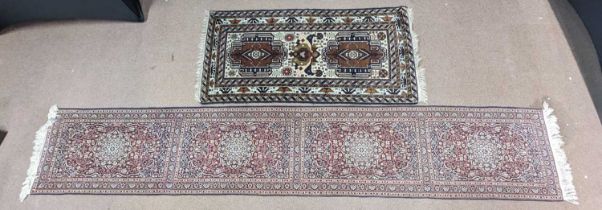 A Bombay runner with floral decoration on a red and blue ground, 444 x 79cm, together with an