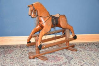 A good quality modern rocking horse, with horsehair mane, height 110cm. Condition Report: Wear and